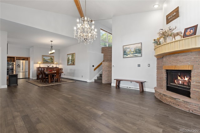 11039 Roxborough Dr, Littleton, CO 80125 - living room with stairs, dark wood-style flooring, a lit fireplace, a chandelier, and baseboards