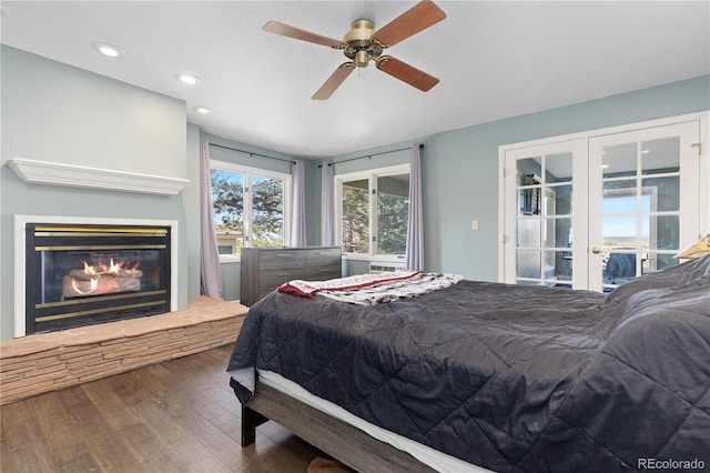 11039 Roxborough Dr, Littleton, CO 80125 - bedroom with wood finished floors, recessed lighting, french doors, a glass covered fireplace, and a ceiling fan