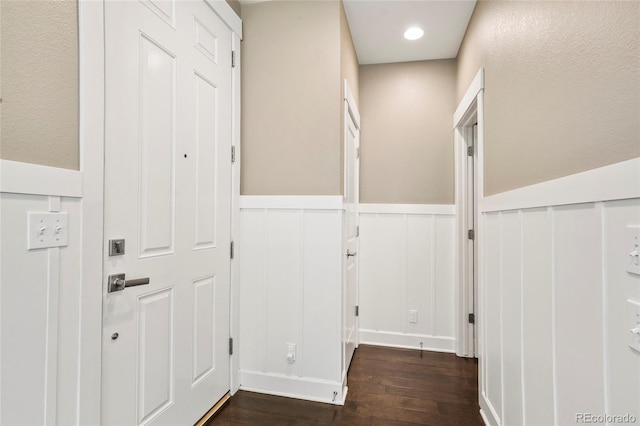 3450 Valentia St, Denver, CO 80238 - hallway featuring dark wood finished floors, a wainscoted wall, and a decorative wall