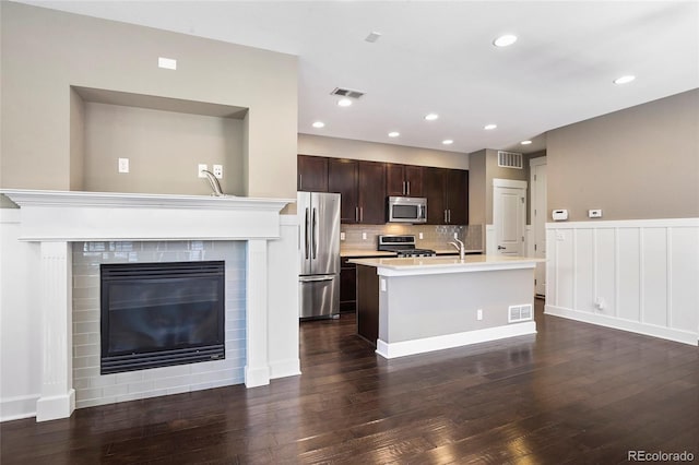 3450 Valentia St, Denver, CO 80238 - kitchen with appliances with stainless steel finishes, light countertops, dark wood finished floors, dark brown cabinetry, and recessed lighting