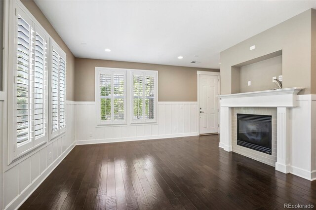 3450 Valentia St, Denver, CO 80238 - unfurnished living room featuring hardwood / wood-style floors, wainscoting, and a glass covered fireplace