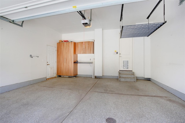 3450 Valentia St, Denver, CO 80238 - garage featuring a garage door opener and baseboards