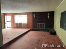 unfurnished living room with carpet flooring