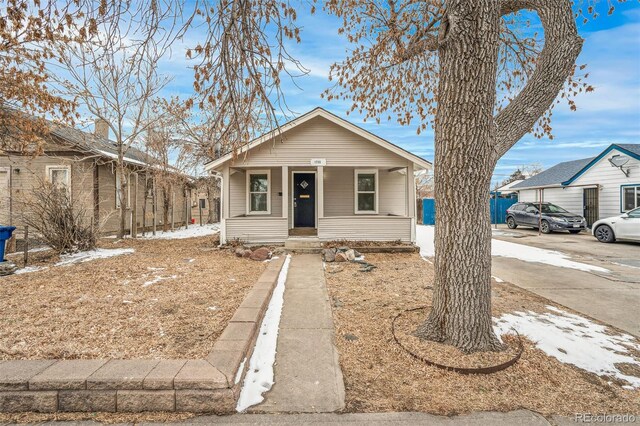 bungalow-style house with covered porch and driveway