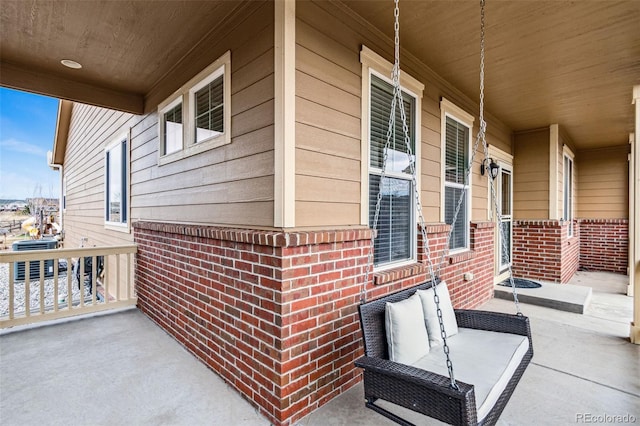 view of patio / terrace featuring central AC unit and a porch