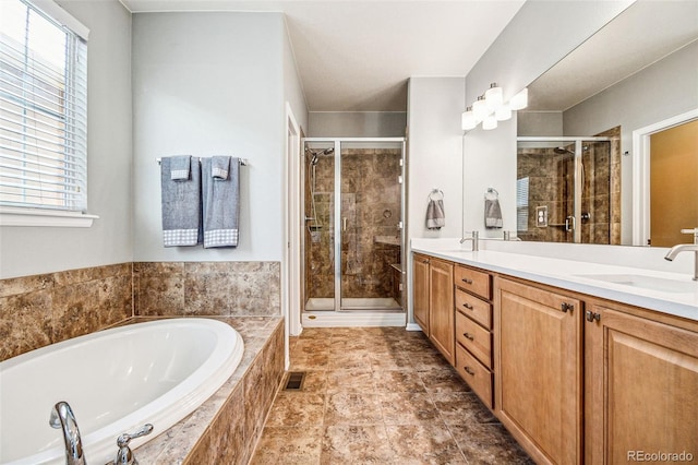 bathroom with a shower stall, a bath, double vanity, and a sink