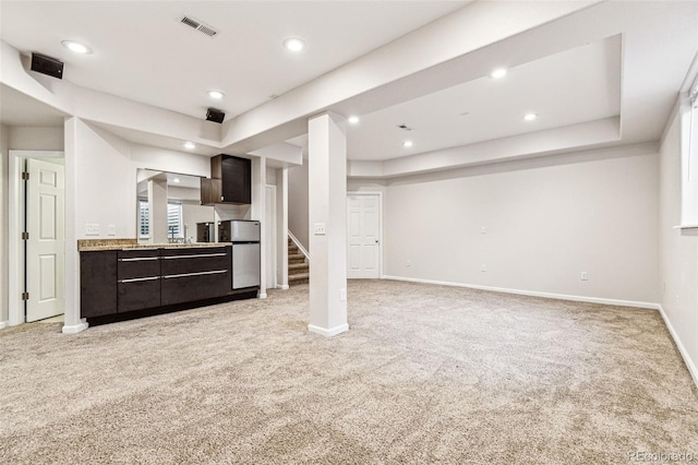 below grade area with visible vents, recessed lighting, baseboards, light colored carpet, and stairs