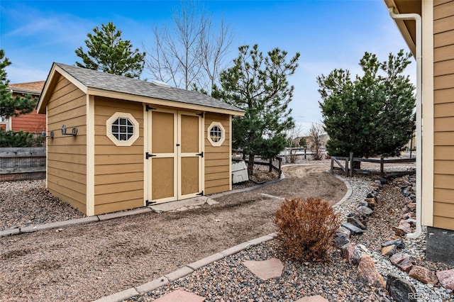 view of shed featuring fence