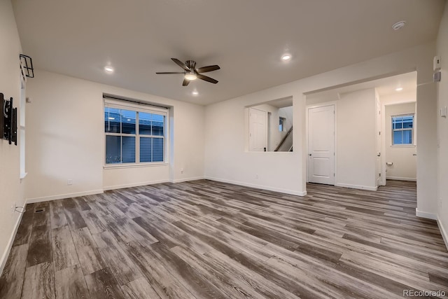 spare room featuring wood-type flooring and ceiling fan