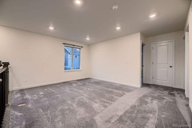 empty room featuring dark colored carpet