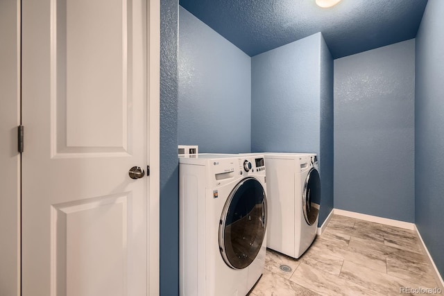 laundry area featuring washer and dryer and a textured ceiling