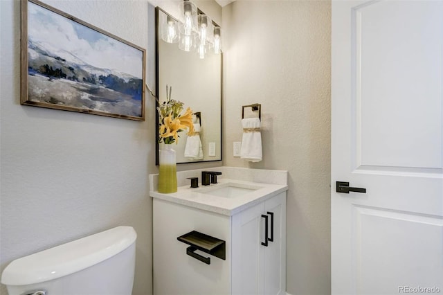 bathroom with toilet and vanity