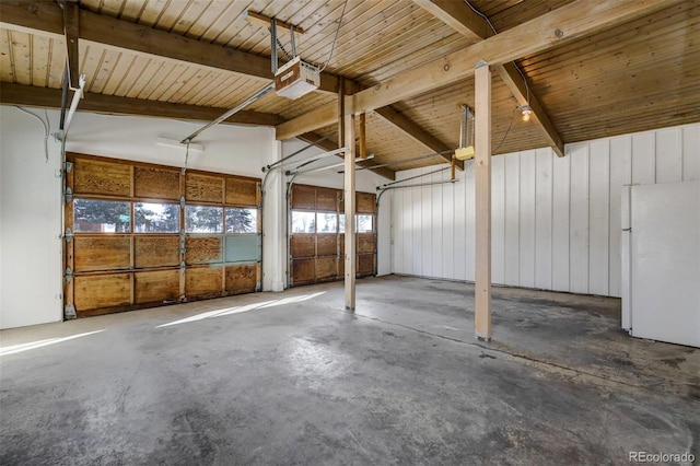 garage with white fridge and a garage door opener