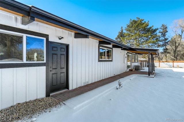 view of snow covered property entrance