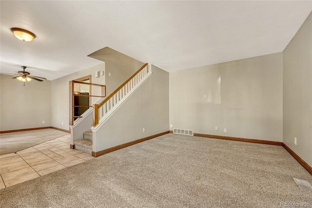 unfurnished living room with ceiling fan and light colored carpet