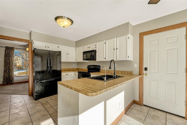 kitchen featuring black appliances, white cabinets, kitchen peninsula, and sink