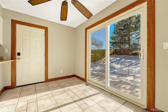 entryway with ceiling fan and light tile patterned flooring