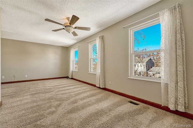 empty room featuring carpet, a textured ceiling, and ceiling fan