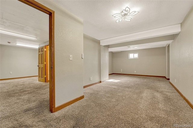 basement with carpet flooring and a textured ceiling