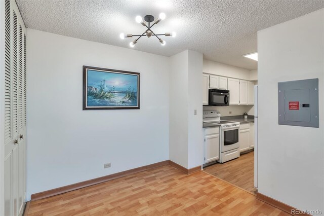 kitchen with white electric range oven, light wood-type flooring, electric panel, and white cabinets