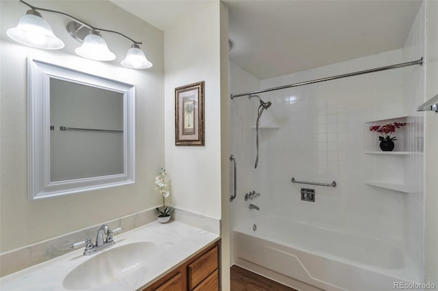 bathroom with vanity, wood-type flooring, and tiled shower / bath combo