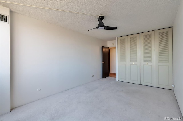 1850 Folsom St Unit 411, Boulder, CO 80302 - unfurnished bedroom with light carpet, a closet, ceiling fan, and a textured ceiling