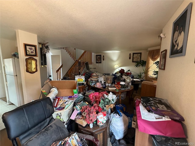 14874 E 52nd Ave, Denver, CO 80239 - living area featuring a textured ceiling and stairway