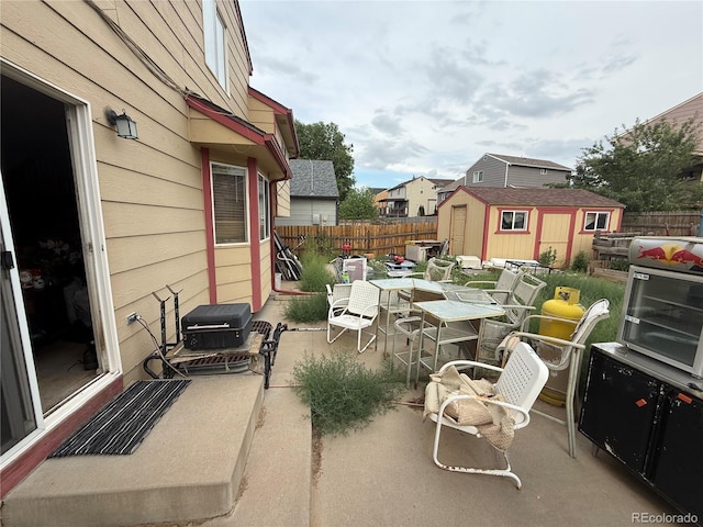 14874 E 52nd Ave, Denver, CO 80239 - fenced backyard with a storage shed, outdoor dining area, and a patio area