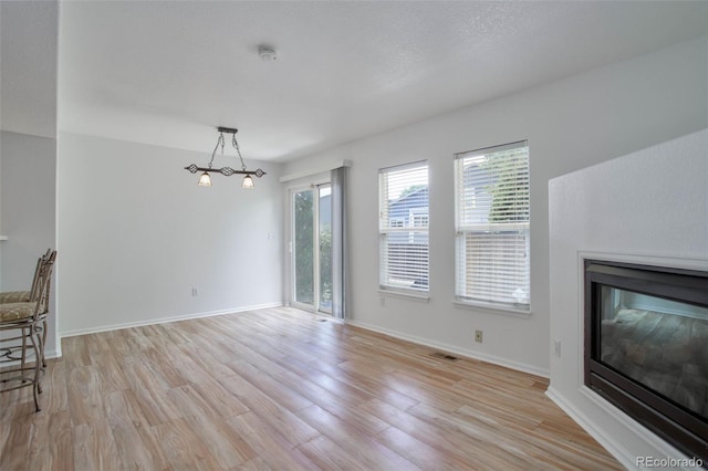 unfurnished living room featuring light wood-type flooring