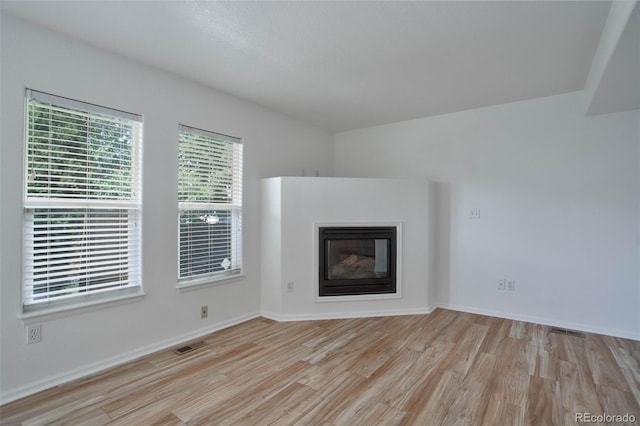 unfurnished living room featuring light hardwood / wood-style flooring