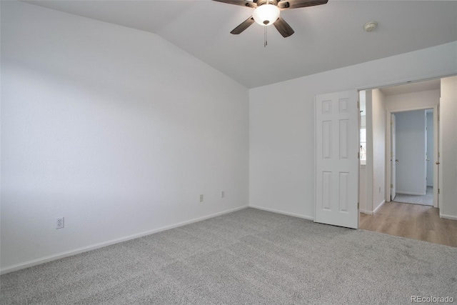 carpeted empty room with lofted ceiling and ceiling fan