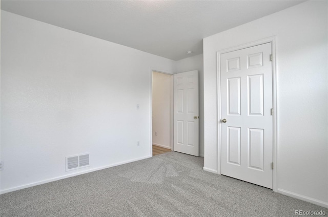 unfurnished bedroom featuring light colored carpet