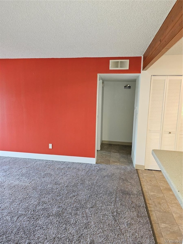 7000 W 20th Ave Unit 106, Lakewood, CO 80214 - carpeted spare room featuring baseboards and a textured ceiling