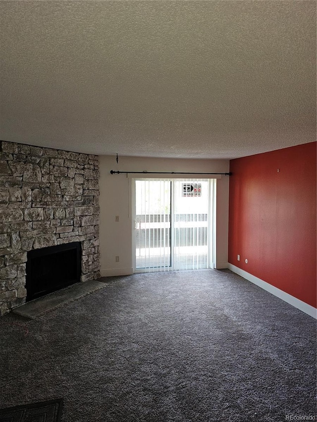 7000 W 20th Ave Unit 106, Lakewood, CO 80214 - unfurnished living room with a textured ceiling, carpet flooring, a fireplace, and baseboards