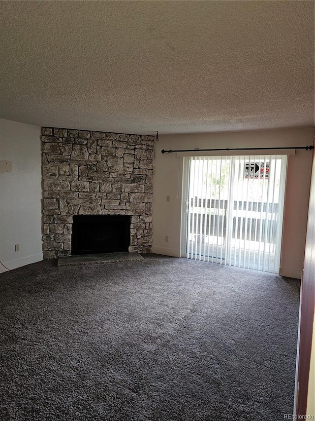 7000 W 20th Ave Unit 106, Lakewood, CO 80214 - unfurnished living room featuring a textured ceiling, a fireplace, carpet floors, and baseboards