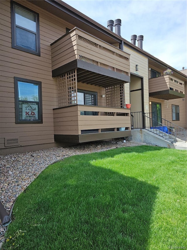 7000 W 20th Ave Unit 106, Lakewood, CO 80214 - back of house with a balcony and a yard