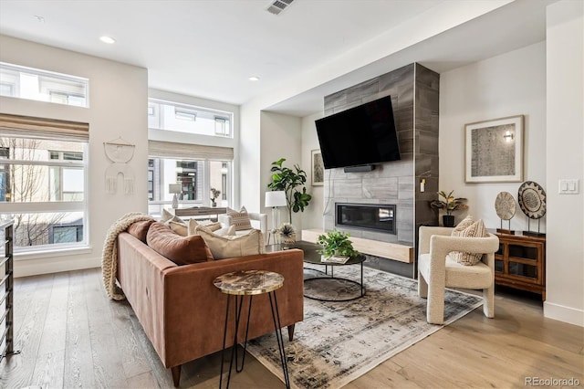 living room with hardwood / wood-style flooring and a fireplace