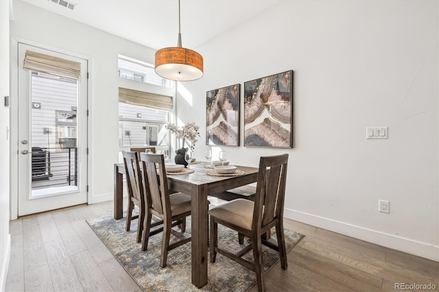 dining space featuring wood-type flooring