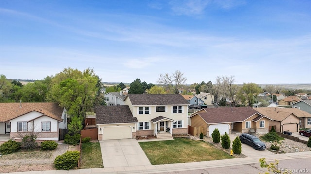 1055 Lindstrom Dr, Colorado Springs, CO 80911 - view of front of home featuring a residential view, driveway, an attached garage, and a front lawn