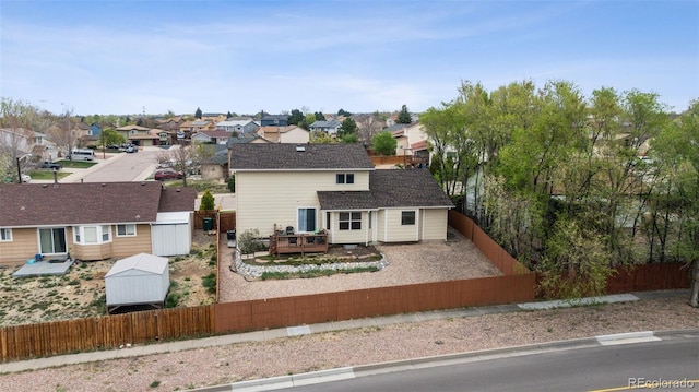 1055 Lindstrom Dr, Colorado Springs, CO 80911 - back of property with a fenced backyard, a wooden deck, a residential view, and an outdoor structure
