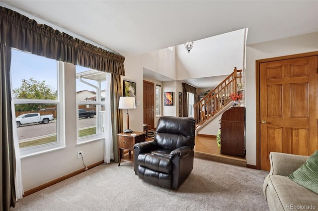 1055 Lindstrom Dr, Colorado Springs, CO 80911 - living area featuring carpet, baseboards, stairway, and lofted ceiling