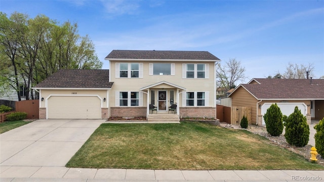1055 Lindstrom Dr, Colorado Springs, CO 80911 - colonial home with an attached garage, brick siding, and driveway