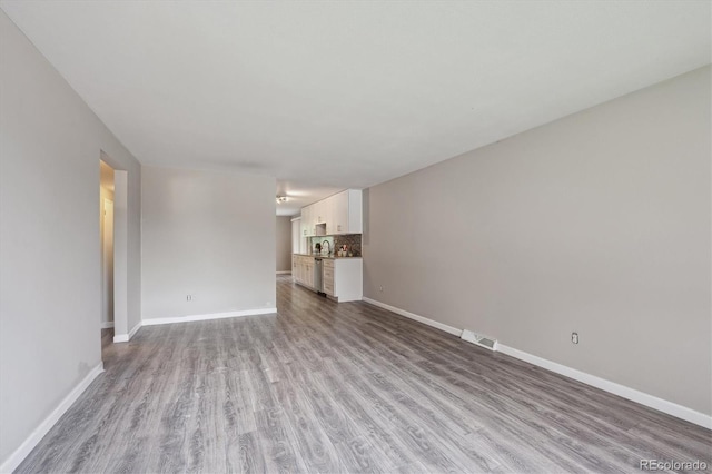 3685 Lewis St, Wheat Ridge, CO 80033 - unfurnished living room with wood finished floors and baseboards