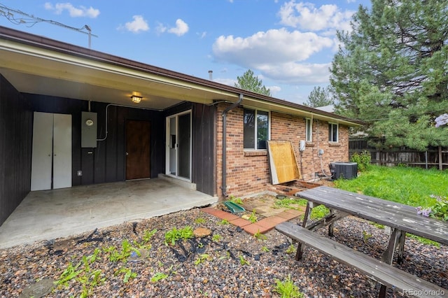3685 Lewis St, Wheat Ridge, CO 80033 - back of house featuring fence, brick siding, and central air condition unit