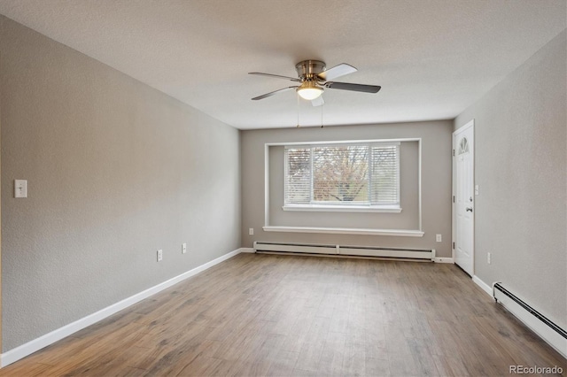 3685 Lewis St, Wheat Ridge, CO 80033 - empty room with a baseboard heating unit, a ceiling fan, wood finished floors, and baseboards