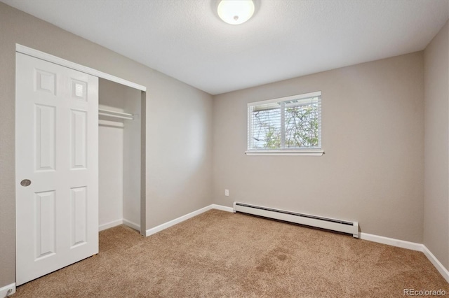3685 Lewis St, Wheat Ridge, CO 80033 - unfurnished bedroom with baseboard heating, carpet, baseboards, and a closet