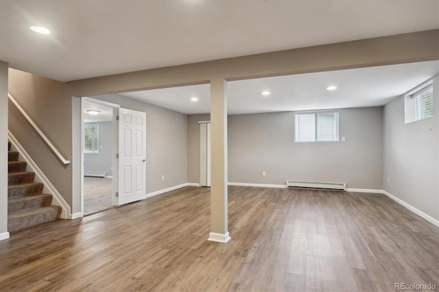 3685 Lewis St, Wheat Ridge, CO 80033 - basement featuring a baseboard heating unit, wood finished floors, stairs, recessed lighting, and baseboards