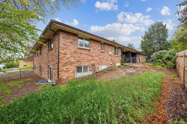 3685 Lewis St, Wheat Ridge, CO 80033 - rear view of house with a fenced backyard and brick siding