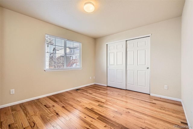 unfurnished bedroom with light hardwood / wood-style floors and a closet