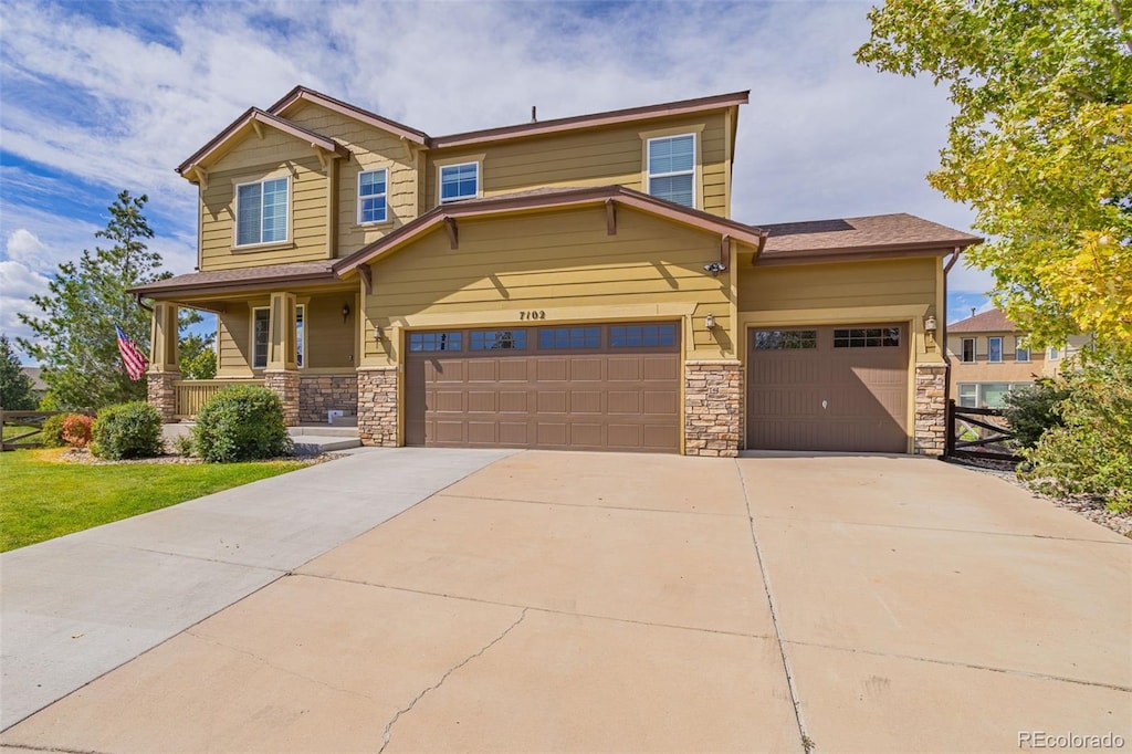 craftsman inspired home featuring a porch and a garage